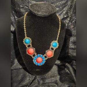 Elegant Gold Necklace with Red and Blue Accents